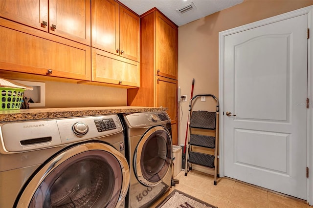 34231 Shadewood Cir, Leesburg, FL 34788 - laundry room featuring cabinet space, washer and dryer, and light tile patterned floors
