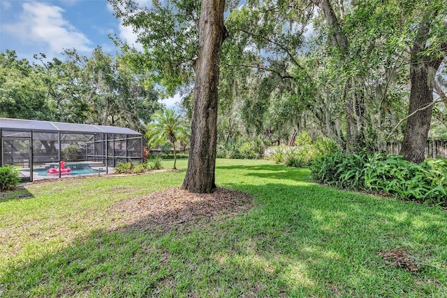 34231 Shadewood Cir, Leesburg, FL 34788 - view of green lawn with an outdoor pool and glass enclosure