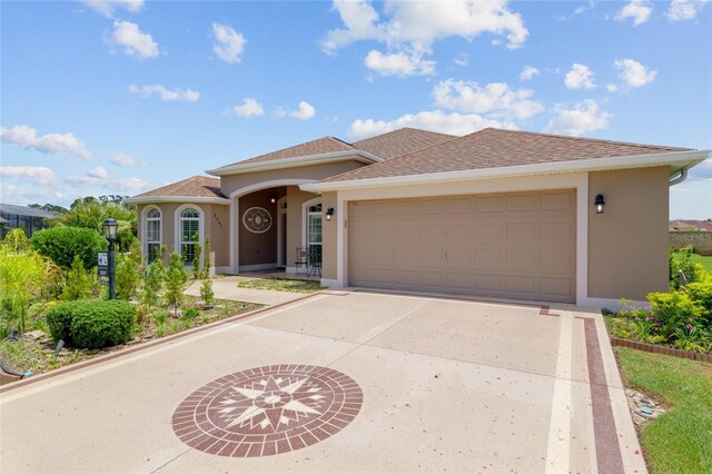 3097 Bureau Path, The Villages, FL 32163 - view of front of home with driveway, stucco siding, an attached garage, and roof with shingles
