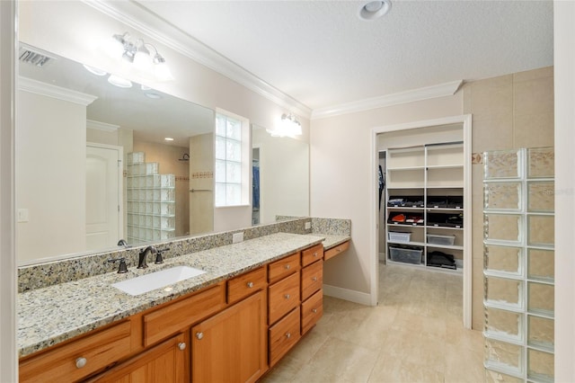 3097 Bureau Path, The Villages, FL 32163 - bathroom featuring vanity, ornamental molding, tiled shower, a spacious closet, and tile patterned flooring