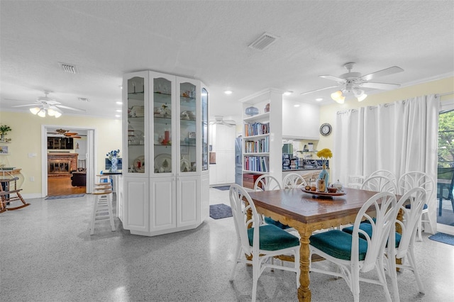 101 Lakeshore Blvd, Saint Cloud, FL 34769 - dining room featuring a ceiling fan, a textured ceiling, and baseboards