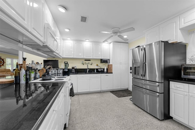 101 Lakeshore Blvd, Saint Cloud, FL 34769 - kitchen with stainless steel refrigerator with ice dispenser, dark countertops, a ceiling fan, and white cabinetry