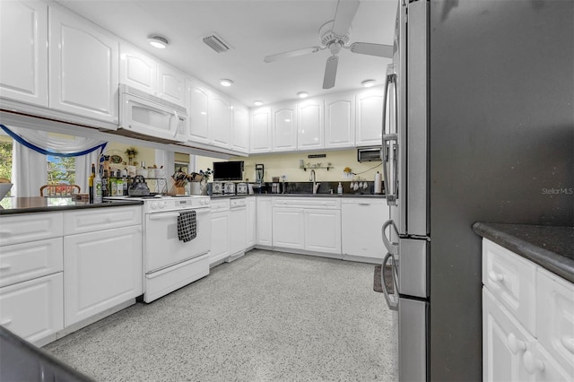 101 Lakeshore Blvd, Saint Cloud, FL 34769 - kitchen featuring white appliances, ceiling fan, dark countertops, and white cabinets