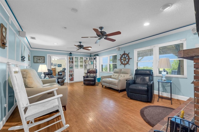 101 Lakeshore Blvd, Saint Cloud, FL 34769 - living room with wood finished floors, a ceiling fan, a textured ceiling, crown molding, and recessed lighting