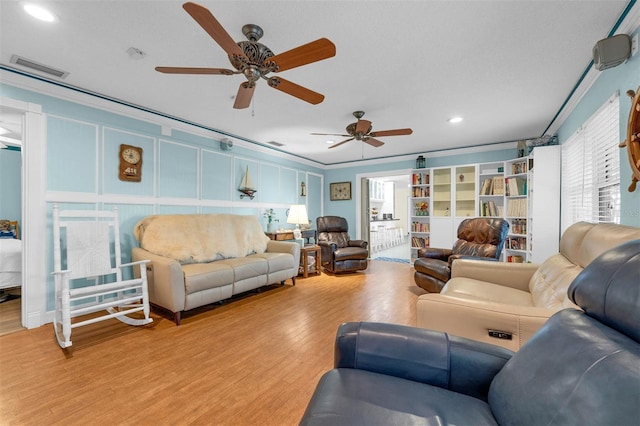 101 Lakeshore Blvd, Saint Cloud, FL 34769 - living area featuring healthy amount of natural light, recessed lighting, ceiling fan, wood finished floors, and ornamental molding