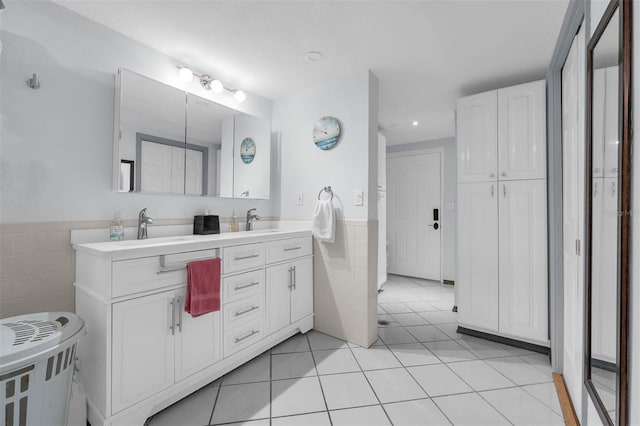 101 Lakeshore Blvd, Saint Cloud, FL 34769 - bathroom featuring tile walls, double vanity, tile patterned floors, recessed lighting, and wainscoting