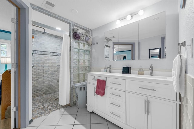 101 Lakeshore Blvd, Saint Cloud, FL 34769 - bathroom featuring a tile shower, double vanity, ensuite bath, and tile patterned flooring