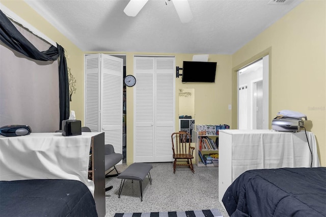 101 Lakeshore Blvd, Saint Cloud, FL 34769 - bedroom featuring two closets, ceiling fan, and a textured ceiling