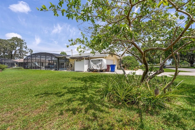 101 Lakeshore Blvd, Saint Cloud, FL 34769 - view of green lawn featuring driveway, a garage, and a lanai