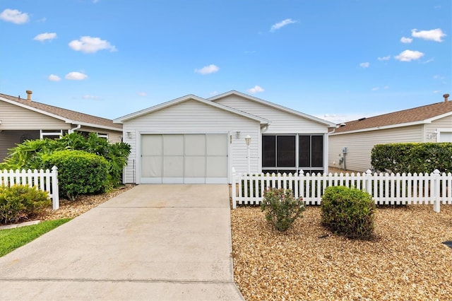 2317 Whisper St, The Villages, FL 32162 - ranch-style home featuring a sunroom, driveway, and an attached garage