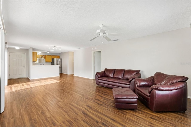 2317 Whisper St, The Villages, FL 32162 - living area with dark wood-style flooring, a textured ceiling, a ceiling fan, and track lighting
