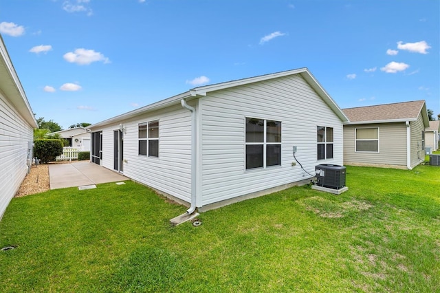 2317 Whisper St, The Villages, FL 32162 - rear view of property with central air condition unit, a yard, and a patio