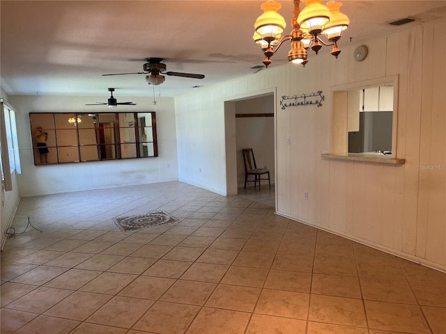 11812 Watts Ct, Tavares, FL 32778 - unfurnished living room featuring light tile patterned floors, a chandelier, and a ceiling fan