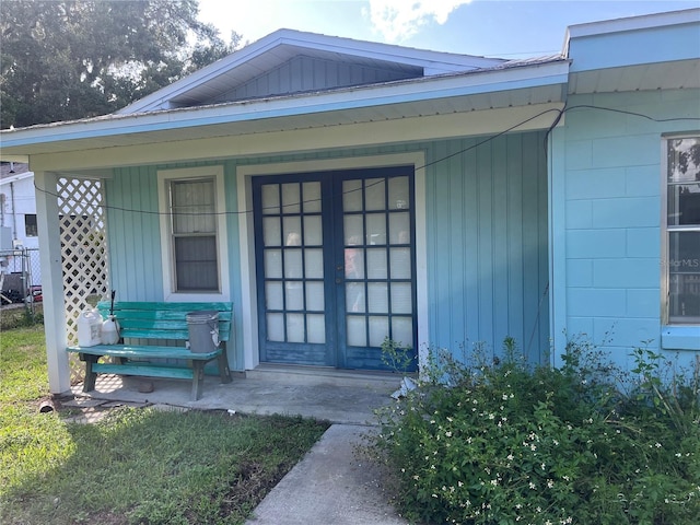 11812 Watts Ct, Tavares, FL 32778 - property entrance featuring covered porch and concrete block siding