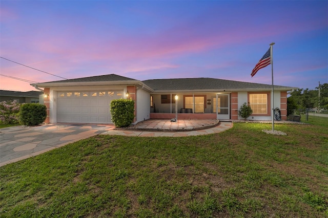 8850 SE 156th St, Summerfield, FL 34491 - ranch-style home with driveway, stucco siding, a front yard, and an attached garage