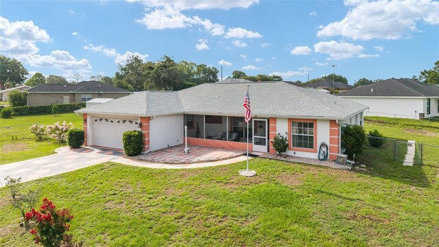 8850 SE 156th St, Summerfield, FL 34491 - ranch-style home featuring a sunroom, a garage, driveway, and stucco siding