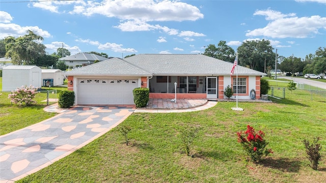 8850 SE 156th St, Summerfield, FL 34491 - single story home featuring an attached garage, concrete driveway, a storage shed, and a sunroom