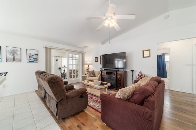 8850 SE 156th St, Summerfield, FL 34491 - living area with a ceiling fan, a glass covered fireplace, wood finished floors, and high vaulted ceiling