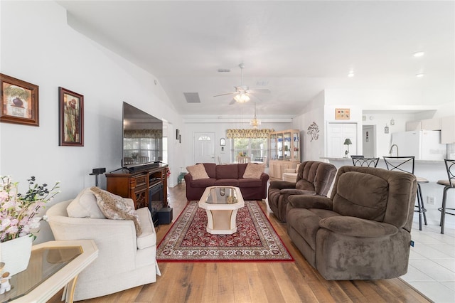 8850 SE 156th St, Summerfield, FL 34491 - living area featuring vaulted ceiling, a ceiling fan, and light wood finished floors
