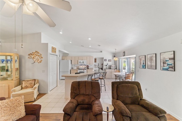 8850 SE 156th St, Summerfield, FL 34491 - living room with vaulted ceiling, a ceiling fan, recessed lighting, and light tile patterned flooring