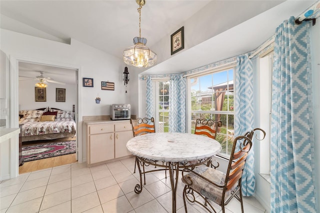 8850 SE 156th St, Summerfield, FL 34491 - dining space featuring light tile patterned floors, a chandelier, and a ceiling fan