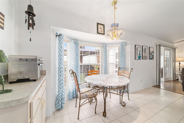 8850 SE 156th St, Summerfield, FL 34491 - dining space with a chandelier and light tile patterned flooring
