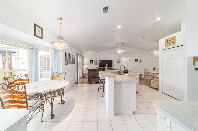 8850 SE 156th St, Summerfield, FL 34491 - kitchen with a chandelier, lofted ceiling, light countertops, light tile patterned floors, and open floor plan
