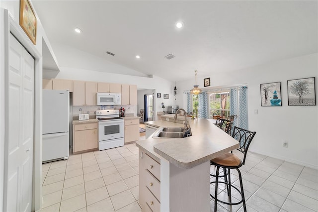 8850 SE 156th St, Summerfield, FL 34491 - kitchen featuring white appliances, light brown cabinetry, vaulted ceiling, light tile patterned floors, and light countertops