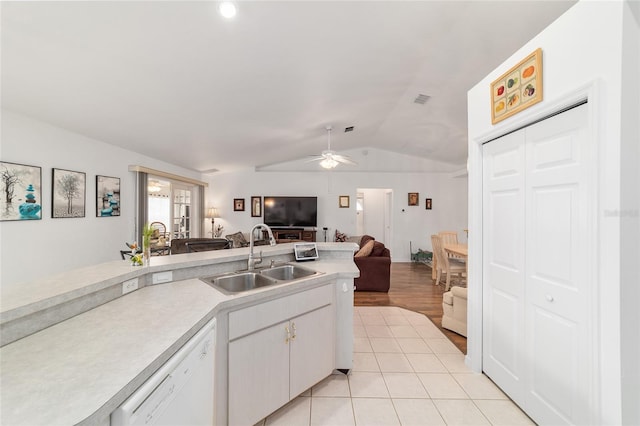 8850 SE 156th St, Summerfield, FL 34491 - kitchen with white dishwasher, lofted ceiling, open floor plan, light countertops, and a ceiling fan