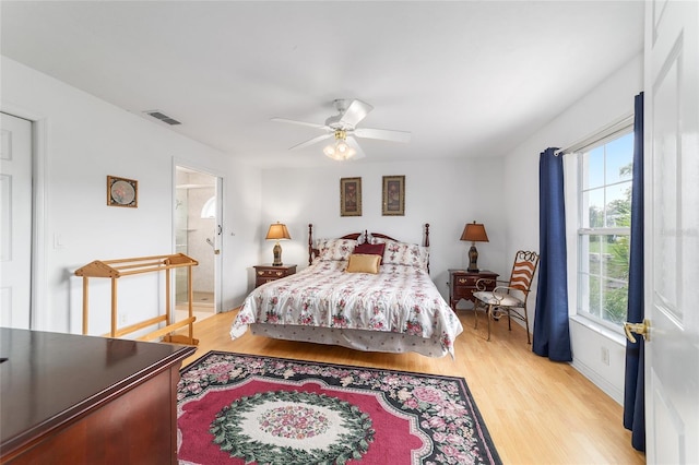 8850 SE 156th St, Summerfield, FL 34491 - bedroom featuring light wood-style floors, ceiling fan, and connected bathroom