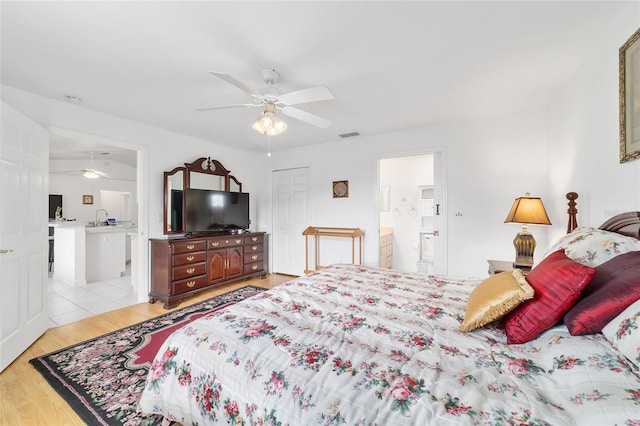8850 SE 156th St, Summerfield, FL 34491 - bedroom featuring ensuite bathroom, light wood finished floors, ceiling fan, and a closet