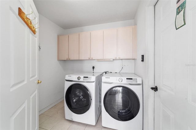 8850 SE 156th St, Summerfield, FL 34491 - laundry area featuring cabinet space, washer and clothes dryer, and light tile patterned floors