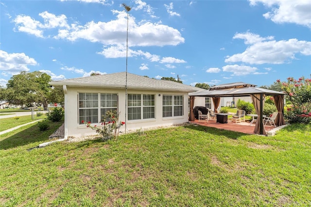 8850 SE 156th St, Summerfield, FL 34491 - back of property with a gazebo, stucco siding, a patio, a lawn, and an outdoor fire pit
