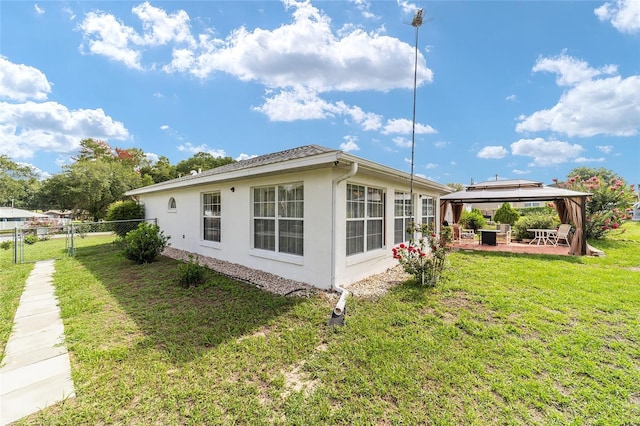 8850 SE 156th St, Summerfield, FL 34491 - view of property exterior with a gazebo, a patio, stucco siding, and a gate