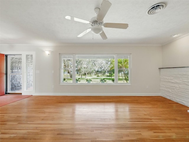 9269 Silver Lake Dr, Leesburg, FL 34788 - unfurnished living room with light wood-style flooring, baseboards, ornamental molding, a ceiling fan, and a textured ceiling