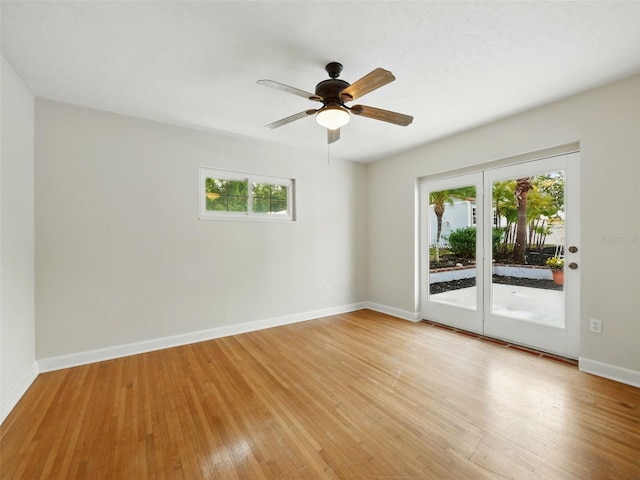 9269 Silver Lake Dr, Leesburg, FL 34788 - empty room featuring healthy amount of natural light, light wood-type flooring, ceiling fan, and baseboards