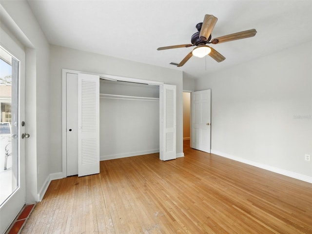 9269 Silver Lake Dr, Leesburg, FL 34788 - unfurnished bedroom featuring light wood finished floors, a closet, baseboards, and ceiling fan