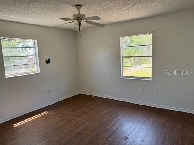 1109 Willow Ct, Tavares, FL 32778 - empty room featuring dark wood-style flooring, ceiling fan, healthy amount of natural light, a textured ceiling, and baseboards