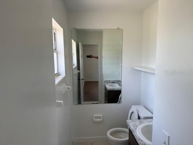 1109 Willow Ct, Tavares, FL 32778 - bathroom featuring toilet, vanity, and tile patterned flooring