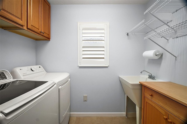 16827 SE 92nd Lance Ct, The Villages, FL 32162 - washroom with washer and clothes dryer, cabinet space, and baseboards