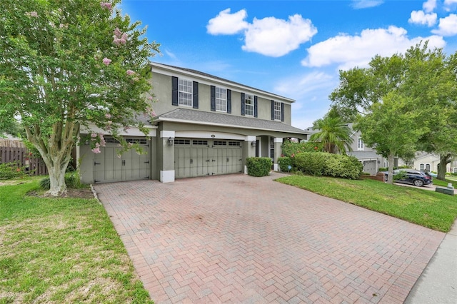 107 Wekiva Pointe Cir, Apopka, FL 32712 - view of front of property with decorative driveway, stucco siding, and a garage