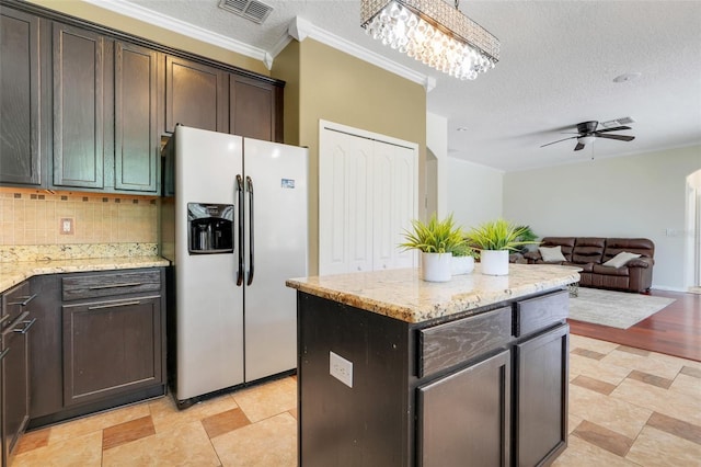 107 Wekiva Pointe Cir, Apopka, FL 32712 - kitchen with fridge with ice dispenser, ornamental molding, a ceiling fan, tasteful backsplash, and a chandelier