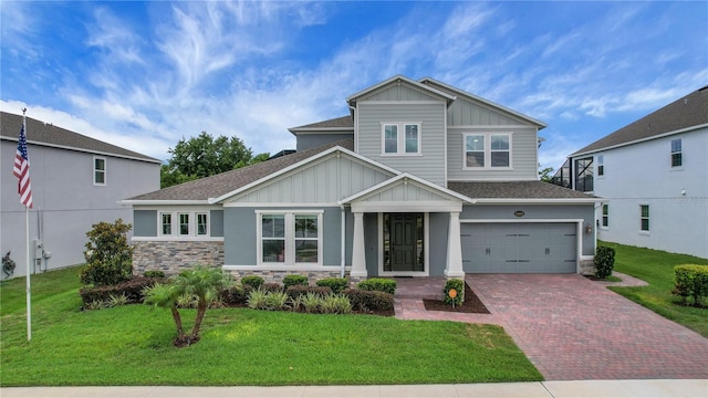 14501 Wabasso Loop, Winter Garden, FL 34787 - view of front of house with board and batten siding, stone siding, and decorative driveway