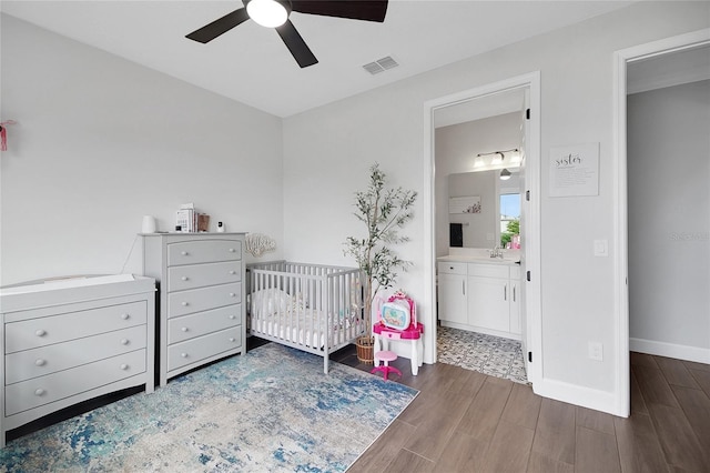 14501 Wabasso Loop, Winter Garden, FL 34787 - bedroom with wood finished floors, a sink, a crib, baseboards, and a ceiling fan