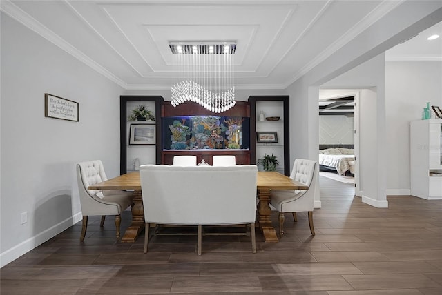 14501 Wabasso Loop, Winter Garden, FL 34787 - dining space with a chandelier, a raised ceiling, wood finished floors, baseboards, and crown molding