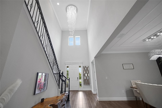 14501 Wabasso Loop, Winter Garden, FL 34787 - entrance foyer with a chandelier, stairway, wood finished floors, crown molding, and baseboards