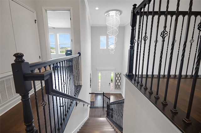 14501 Wabasso Loop, Winter Garden, FL 34787 - stairs featuring wood finished floors, a chandelier, plenty of natural light, baseboards, and crown molding