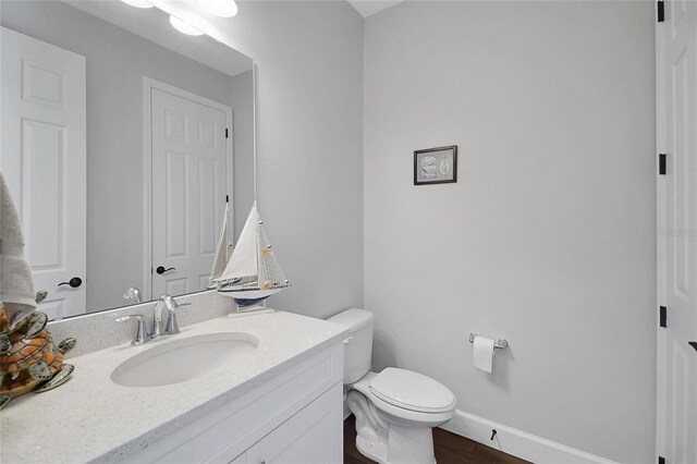 14501 Wabasso Loop, Winter Garden, FL 34787 - bathroom with vanity, toilet, baseboards, and wood finished floors