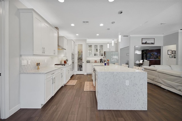 14501 Wabasso Loop, Winter Garden, FL 34787 - kitchen with crown molding, open floor plan, dark wood-type flooring, recessed lighting, and decorative backsplash