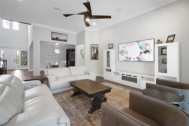 14501 Wabasso Loop, Winter Garden, FL 34787 - living room featuring a towering ceiling, ornamental molding, ceiling fan, baseboards, and wood finished floors